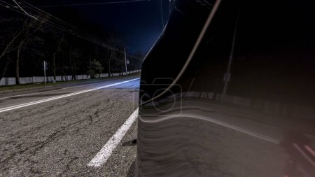 Photo for Driving at high speed through the streets timelapse drivelapse hyperlapse. View from side of car with slider movement at night city road - Royalty Free Image
