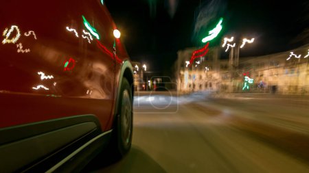 Photo for Drivelapse from side of fast car moving on a night avenue in city timelapse hyperlapse, road with lights reflected on car on high speed. Rapid rhythm of a modern city. Blurred motion - Royalty Free Image