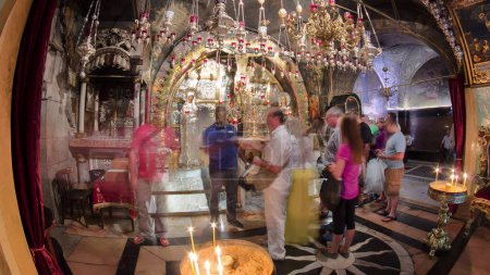 Photo for Icons and candles in the Church of the Holy Sepulcher timelapse hyperlapse. Sacred place in the Christian Quarter of the Old City of Jerusalem where Jesus was crucified and buried. - Royalty Free Image