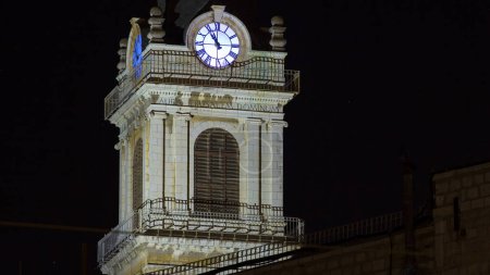 Photo for Church clock tower night timelapse - Terra Santa High School in Old Jerusalem. Close up view. Israel - Royalty Free Image
