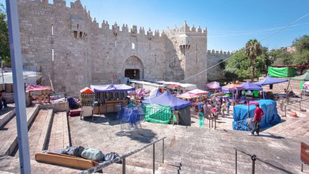 Photo for Damascus Gate or Shechem Gate with stairs around it timelapse hyperlapse, one of the gates to the Old City of Jerusalem, Israel. Crowd of people near entrance - Royalty Free Image
