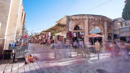 Photo for The colorful souk near church in the old city of Jerusalem Israel timelapse hyperlapse. People passing by on this makret - Royalty Free Image