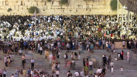 Photo for Religious Jews sunset prayer service at the Western Wall, Israel timelapse. Crowd of people at evening. Aerial view from the top during shabbat. - Royalty Free Image