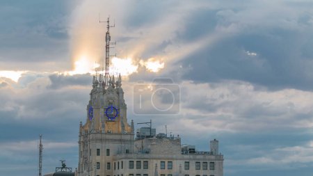 Photo for Telefonica Building is a Manhattan-style skyscraper at Gran Via with rays of sun at sunset time, Madrid, Spain. Telefonica Building is the tallest building in downtown Madrid rooftop aerial view - Royalty Free Image