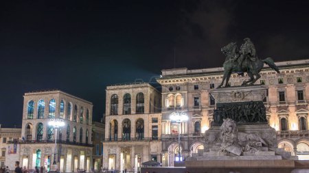 Photo for Vittorio Emanuele II statue at Piazza del Duomo timelapse at night. Milan in Lombardy, Italy. Museum on background. Summer day - Royalty Free Image