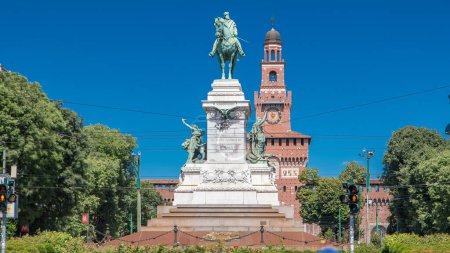 Photo for Giuseppe Garibaldi horse monument on Largo Cairoli and tower of the Sforza Castle - Castello Sforzesco timelapse, Milan, Italy. Blue sky at summer day. People walking around. - Royalty Free Image