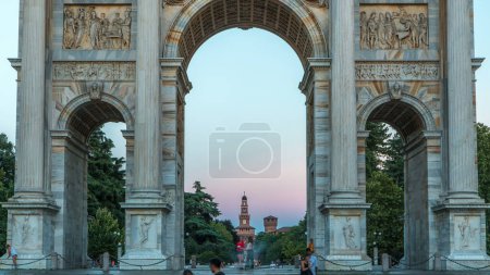 Photo for Arco della Pace in Piazza Sempione (Arch of Peace in Simplon Square) day to night transition timelapse. Evening illumination. Sforza Castle on background. It is a neoclassical triumph arch - Royalty Free Image