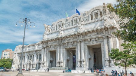 Foto de Milano Centrale timelapse in Piazza Duca d 'Aosta es la principal estación ferroviaria de la ciudad de Milán en Italia. Cielo azul nublado en el día de verano - Imagen libre de derechos