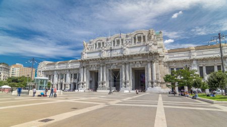 Photo for Milan antique central railway station timelapse hyperlapse. Blue cloudy sky at summer day. The station was inaugurated in 1931. - Royalty Free Image