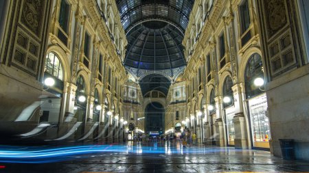 Photo for Entrance to the Galleria Vittorio Emanuele II timelapse from Via Tommaso Grossi at night. This gallery is tourist attraction of Milan. People walking inside - Royalty Free Image