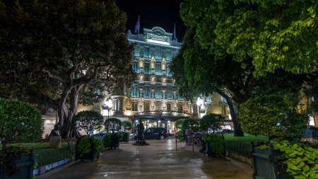 Photo for Hotel Hermitage in Monte Carlo illuminated by night timelapse hyperlapse, Monaco. Park in front of it. This historic luxury hotel was built in the early 1900s in the heart of Monte-Carlo. - Royalty Free Image
