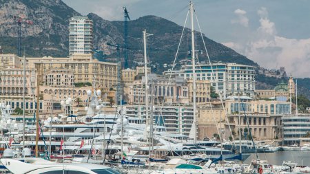 Photo for Monte Carlo city aerial timelapse. View of casino and luxury yachts, boats and historic buildings in harbor of Monaco, Cote d'Azur. Port Hercule from top. - Royalty Free Image