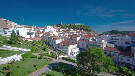 Castle in green trees with houses with red roof near the city Sesimbra, Atlantic coast of Portugal panoramic timelapse. Palmela