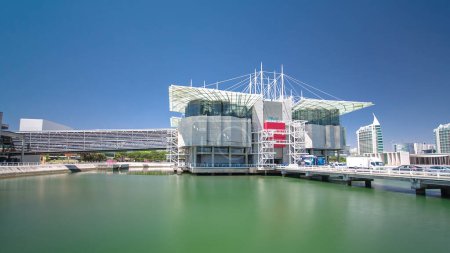 Photo for Lisbon Oceanarium, the second largest oceanarium in the world and the biggest in Europe. Parque das Nacoes. Portugal. Timelapse hyperlapse with blue sky and green water - Royalty Free Image