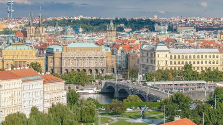 Beautiful View On Prague In Czech Republic With Flowing River Vltava, manes bridge, Church of our lady before Tyn And With Zizkov Television Tower In Background. View from above near Prague castle