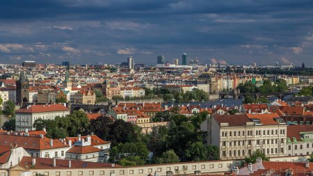 Panorama of Prague Old Town with red roofs timelapse, famous Charles bridge and Vltava river, Czech Republic. View from above near Prague castle before sunset