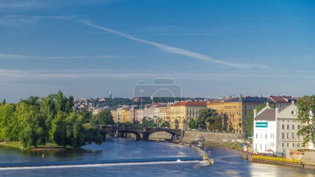 Vltava river timelapse in district Strelecky ostrov with the bridge of the Legions (Most legii) early morning, Prague, Czech Republic