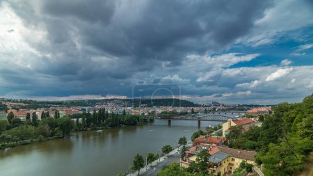 Aerial panoramic view of Prague timelapse from the observation deck of Visegrad. Prague. Czech Republic. Vltava river and bridges. Stormy weather with dark clouds