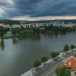 Aerial view of Prague timelapse from the observation deck of Visegrad. Prague. Czech Republic. Vltava river and bridges with traffic on a road. Stormy weather with dark clouds