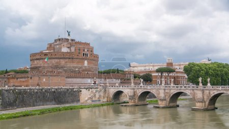 Foto de Saint Angel castle timelapse and bridge over the Tiber river in Rome, Italy. Cloudy sky - Imagen libre de derechos