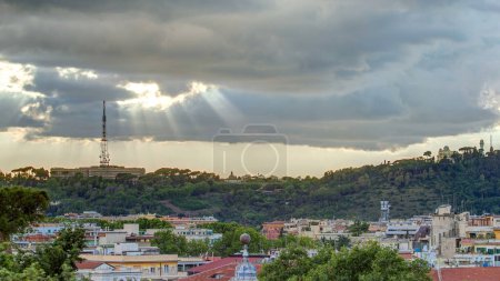 Cityscape of Rome timelapse under a dramatic sky as seen from the Pincio hill, Italy. Top view with rays of sun