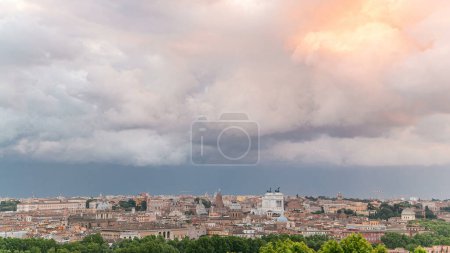 Photo for Panoramic aerial view of historic center timelapse of Rome, Italy. Cityscape with heavy dramatic colorful clouds and rain before sunset - Royalty Free Image