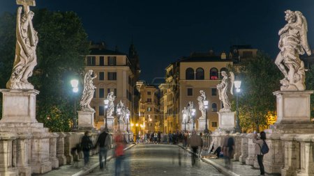 Photo for Ponte Sant'Angelo bridge timelapse crossing the river Tiber near Castel Sant'Angelo, mausoleum of Hadrian, now a museum and art gallery illuminated at night in the heart of Rome. - Royalty Free Image