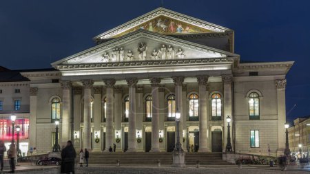 Photo for Munich National Theatre or Nationaltheater on Max Joseph square day to night transition timelapse. Historic opera house, home of the Bavarian State Opera. Evening illumination after sunset. Germany - Royalty Free Image