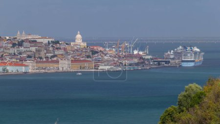 Photo for Aerial view of Lisbon over Tagus river from viewpoint of Cristo Rei in Almada with yachts tourist boats timelapse. Historic district with red roofs. Pantheon dome on the top. Lisbon, Portugal - Royalty Free Image