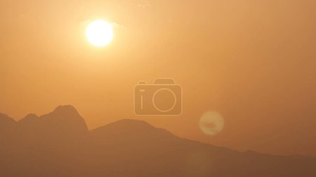 Photo for Seascape timelapse of high mountains over clear sunset sky in Turkey. Close up view with orange sky - Royalty Free Image