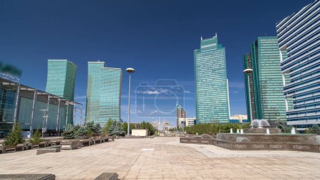 Photo for Fountain on Water-Green Boulevard in Nur-Sultan, Nurzhol Boulevard of Kazakhstan, a pedestrian area in the new business and administrative center of Astana. Green skyscrapers around - Royalty Free Image