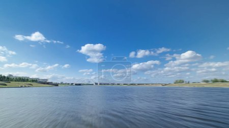 Astana, Kazakhstan. Travel view from Pleasure boat in movement on the river Ishim timelapse hyperlapse drivelapse in Astana. At summer day with blue sky and clouds. Blurred motion
