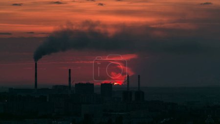Aerial view with sunrise over the city center with smoking pipes and central business district timelapse from rooftop, Nur-Sultan city, Kazakhstan, Central Asia