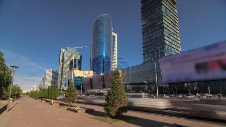 Photo for New business district timelapse hyperlapse on Boulevard with traffic on road and green modern towers in the capital of Kazakhstan in Astana. Nur-Sultan city - Royalty Free Image