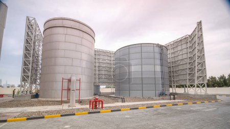 Photo for Two big silver Water Tanks with fence timelapse. Part of cooling system. Cloudy sky - Royalty Free Image