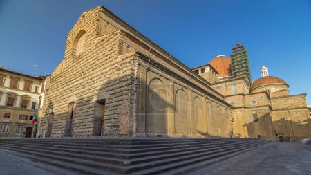 Basilica di San Lorenzo (Basilica of St Lawrence) timelapse hyperlapse in Florence city. Shadow moving on facade. Blue sky at summer morning