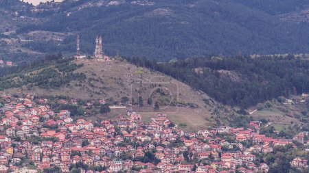 Photo for City panorama with houses and mountains from Old Jewish cemetery timelapse in Sarajevo. Skyline at evening before sunset. Bosnia and Herzegovina - Royalty Free Image