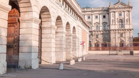 Exterior of outer castle gate (Burgtor) from Ringstrasse timelapse in Vienna city in sunny day. Blue cloudy sky. The gate of Hofburg area was erected in 1818