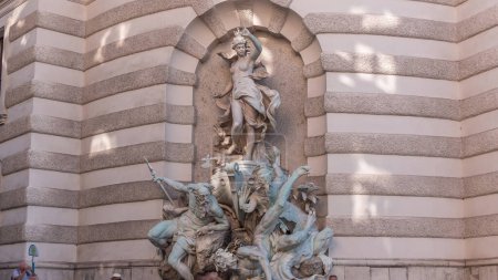 Photo for Fountain Austria, which conquers the sea timelapse in Vienna. Michaelerplatz Square at the entrance to the Hofburg Palace - Royalty Free Image