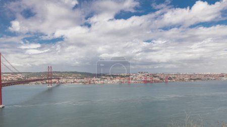 Photo for Panorama showing Lisbon cityscape with landmark suspension 25 of April bridge and Tagus river timelapse, aerial view of Old Town Alfama from viewpoint of Cristo Rei in Almada. Portugal - Royalty Free Image