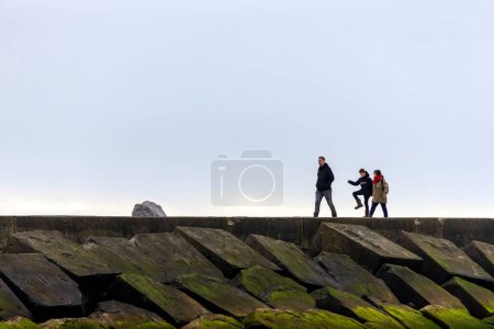 Photo for Family walks on the Pier of Ijmuiden, Netherlands - Royalty Free Image