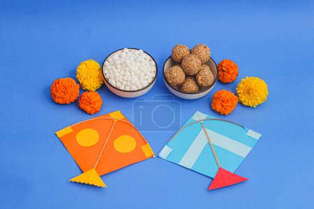 Photo for Happy Makar Sankranti, Pongal and Uttarayan with Kites, haldi kum kum bowls and tilgul sweets - Royalty Free Image