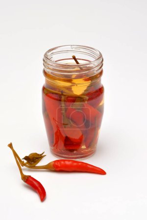 Photo for Hot piri piri peppers in a jar on a white background - Royalty Free Image