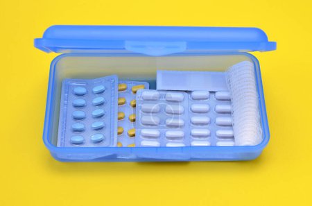 Foto de Box with different medicines on yellow background - Imagen libre de derechos