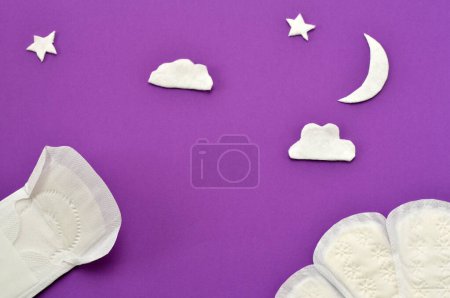 Photo for Women's pads, stars and moon made of cotton on a purple background - Royalty Free Image