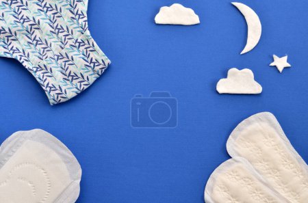 Photo for Women's underpants and sanitary pads, a cotton moon symbolizing protection at night - Royalty Free Image