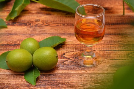 drink from green walnuts and branches on the table