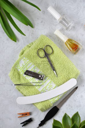items for hand and nail care, scissors, nail file and cosmetics on a light background, flat lay