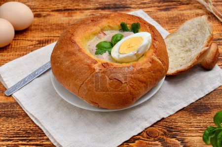 Polish national soup for Easter Zurek in bread close-up
