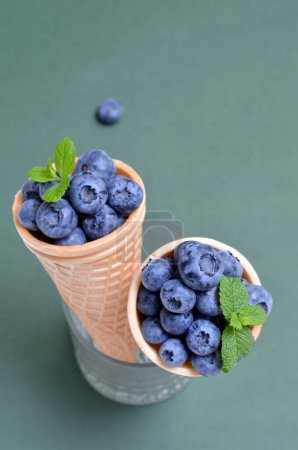 waffle cones with summer berries blueberries food background, copy space